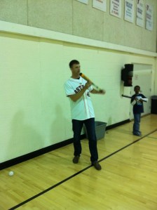 Jordan Lyles shows kids how to bunt. Something he won't really have to do anymore with the Astros move to the AL.